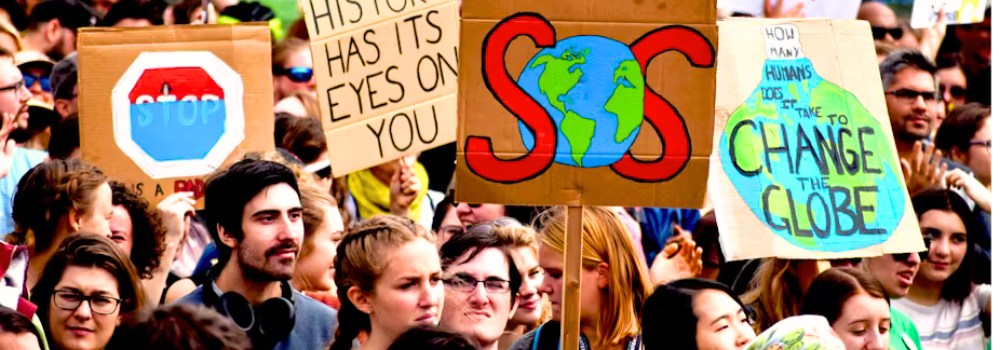 Protesters holding climate change signs expressing concern for the planet and the future.