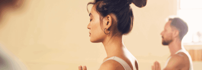 People practising mindfulness and meditation in a calm, indoor setting.