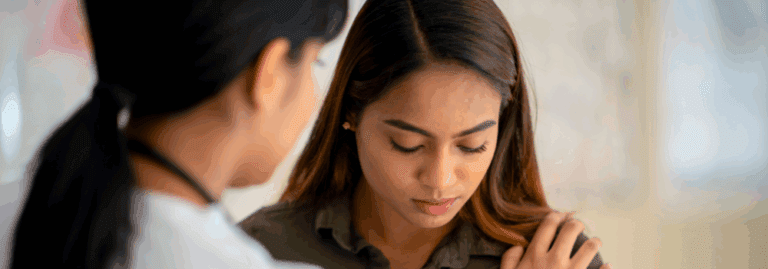 Mental health professional offering support to a patient during a clinical conversation.