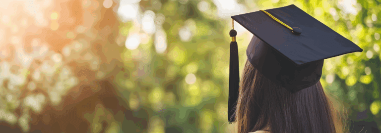 A university graduate wearing a cap outdoors, symbolising new beginnings and career opportunities in mental health.