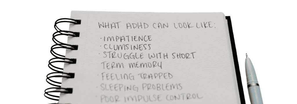 Handwritten notebook listing common ADHD symptoms including impatience, memory difficulties, sleep problems and impulse control challenges.
