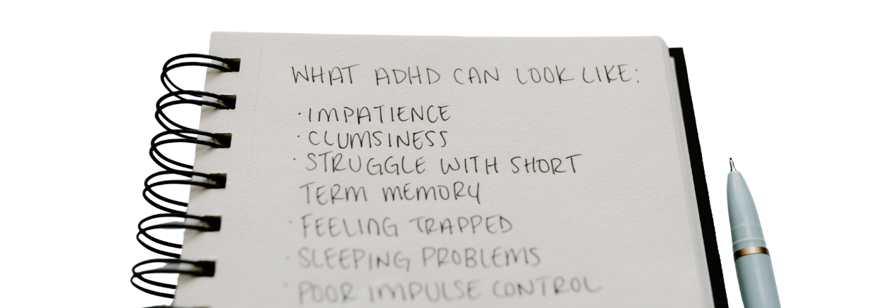 Handwritten notebook listing common ADHD symptoms including impatience, memory difficulties, sleep problems and impulse control challenges.