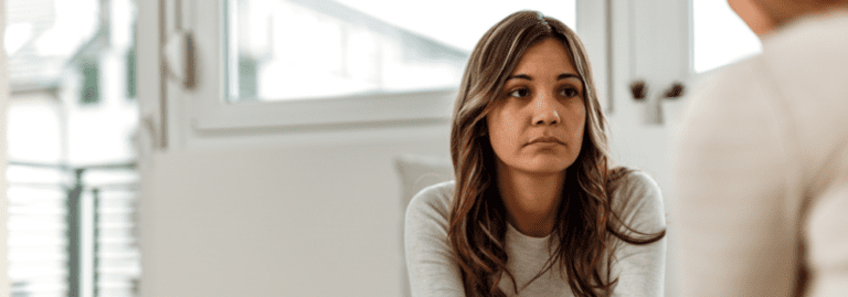 Approved Mental Health Professional speaking with a patient during a mental health assessment in a community setting